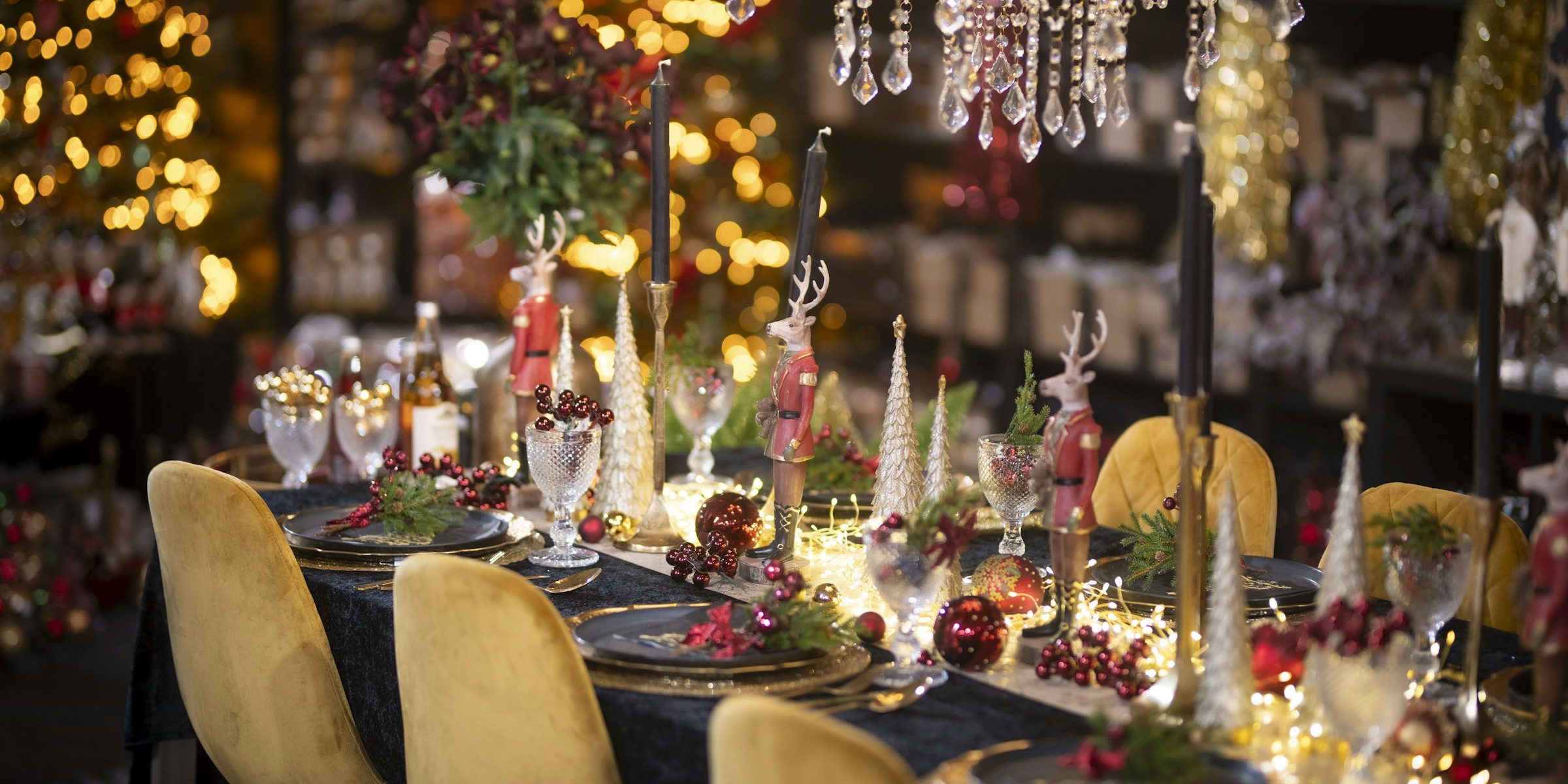 Festive holiday party table with golden chairs and lights