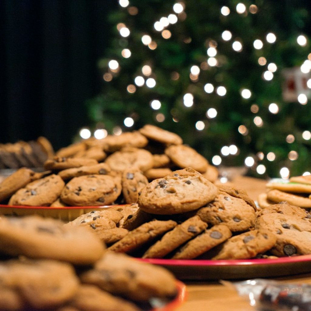 Holiday cookies in front of a Christmas tree