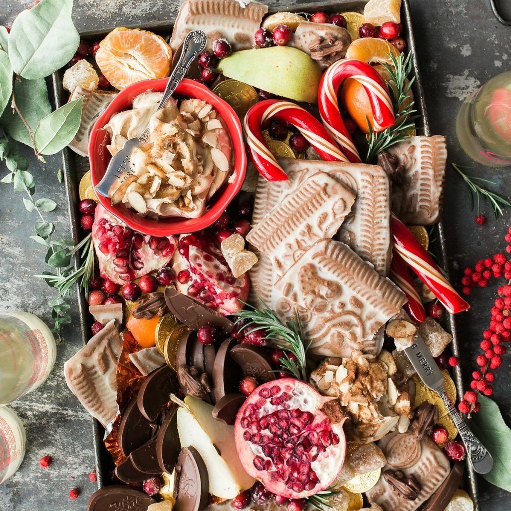 Holiday grazing board with fruit, cookies, and chocolates